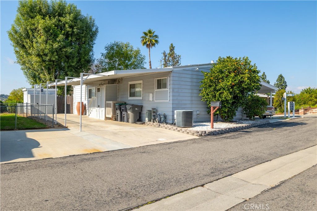 15181 Van Buren, Unit 90 Riverside, CA 92504 - Photo 2 of 27 a front view of a house with a yard and garage