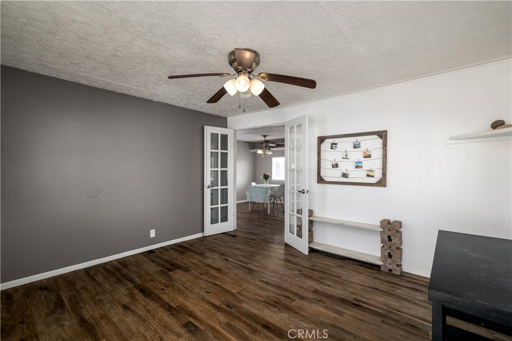 15181 Van Buren, Unit 90 Riverside, CA 92504 - Photo 5 of 27 a view of livingroom with hardwood floor and ceiling fan
