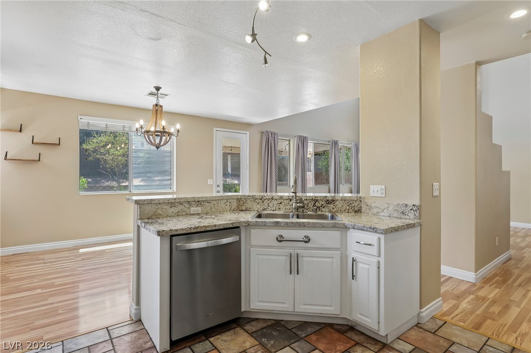 1727 Millstream Way Henderson, NV 89074 - Photo 18 of 46 Granite counters and stainless steel appliances complete this bright, open-concept kitchen.
