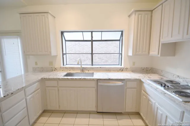 a kitchen with a sink stove and cabinets
