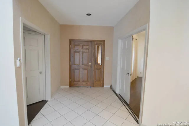 a view of a hallway with bathroom