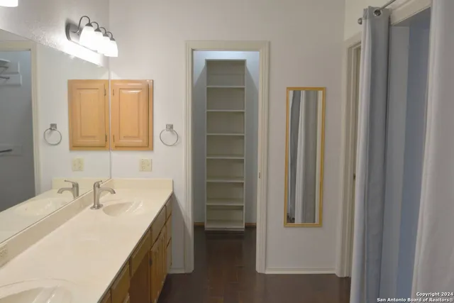 a bathroom with a sink vanity and a mirror