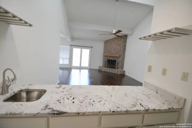 a view of a kitchen counter top a sink and dishwasher