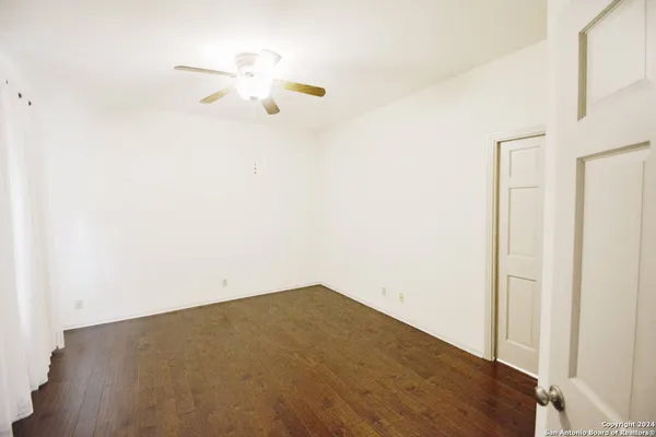 a view of a room with wooden floor