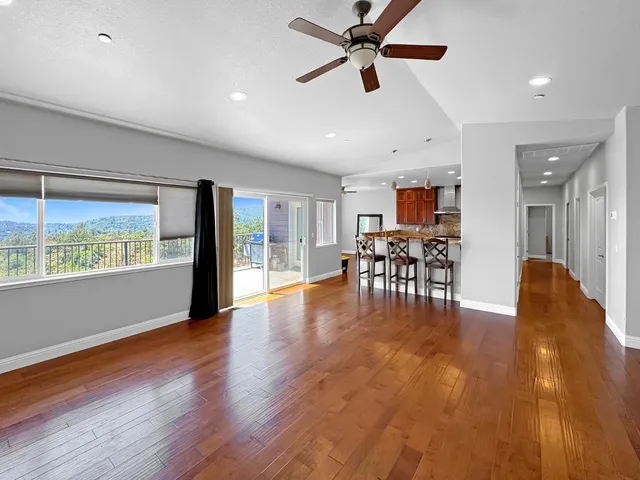 a view of a work space with furniture wooden floor and chandelier