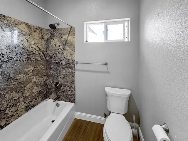 a bathroom with a toilet and a bathtub