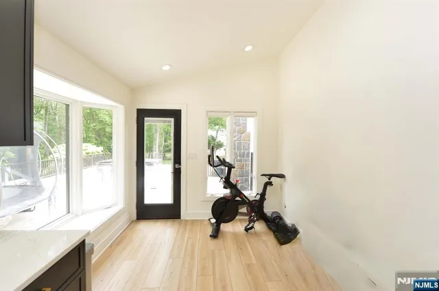 a view of a room with gym equipment and large windows