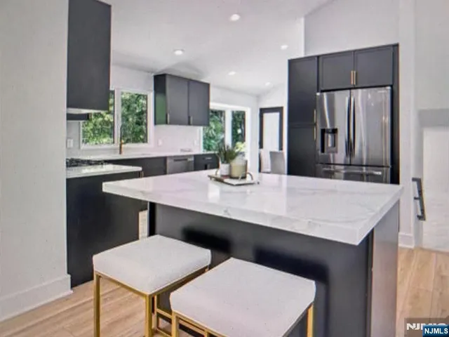 a kitchen with a table chairs and refrigerator