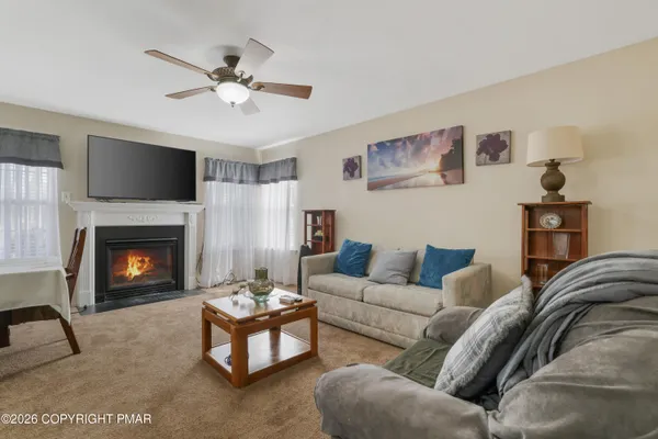 a living room with furniture and a fireplace