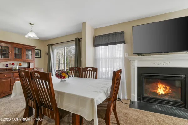 a view of a dining room with furniture and a fireplace
