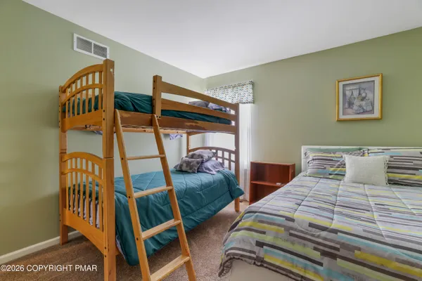 a bedroom with two beds and a window