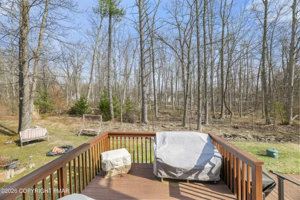 a view of balcony with wooden floor and outdoor seating