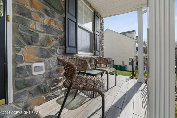 a balcony with table and chairs
