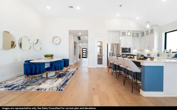 a living room with stainless steel appliances kitchen island granite countertop furniture a rug and a view of kitchen
