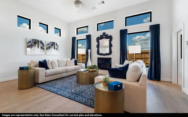 a living room with furniture and a floor to ceiling window