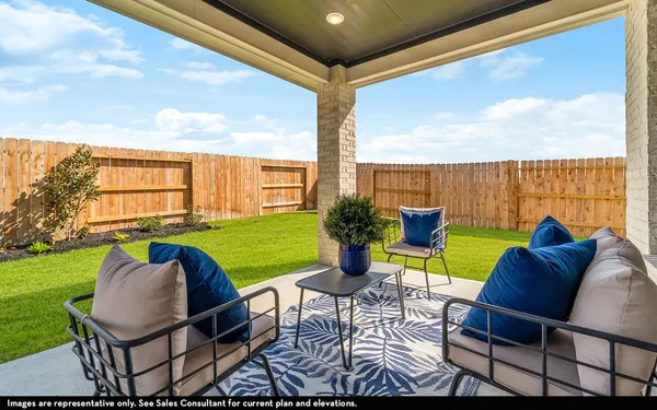 a view of a patio with lawn chairs next to a yard