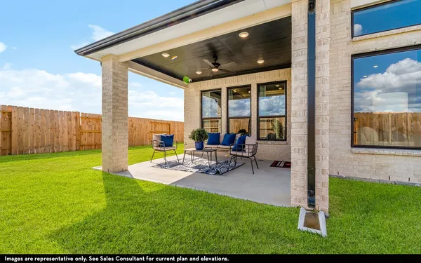 a view of a house with backyard porch and sitting area