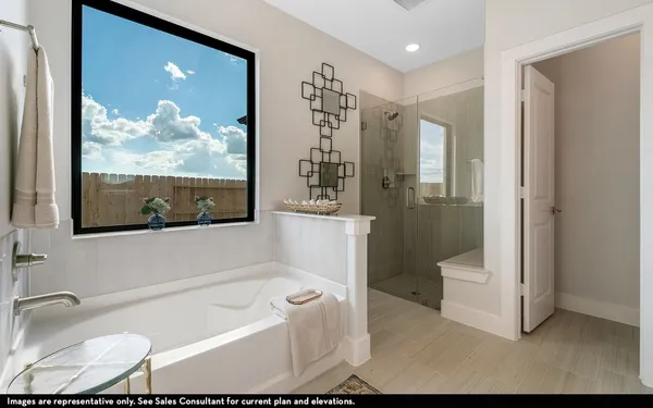 a bathroom with a tub a toilet and a shower