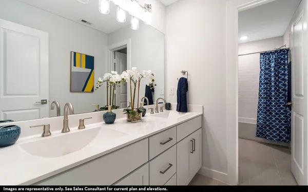 a bathroom with a double vanity sink mirror and