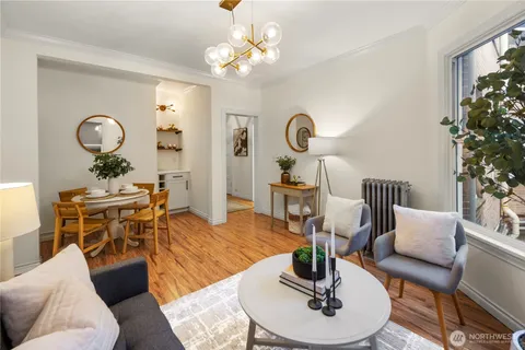 a living room with furniture a chandelier and a table