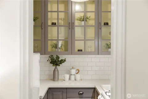 a kitchen with a sink a stove and cabinets