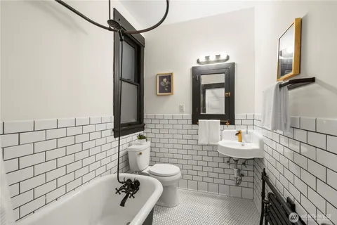 a bathroom with a toilet sink and mirror