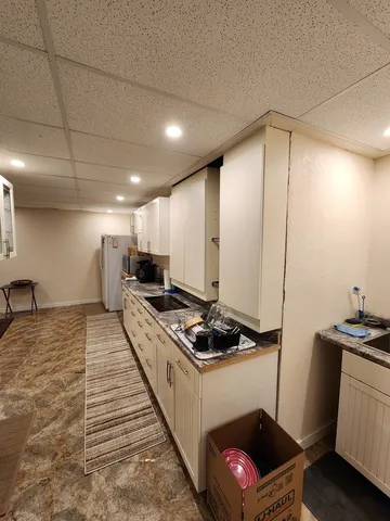 a kitchen with stainless steel appliances kitchen island granite countertop a stove a sink and a refrigerator