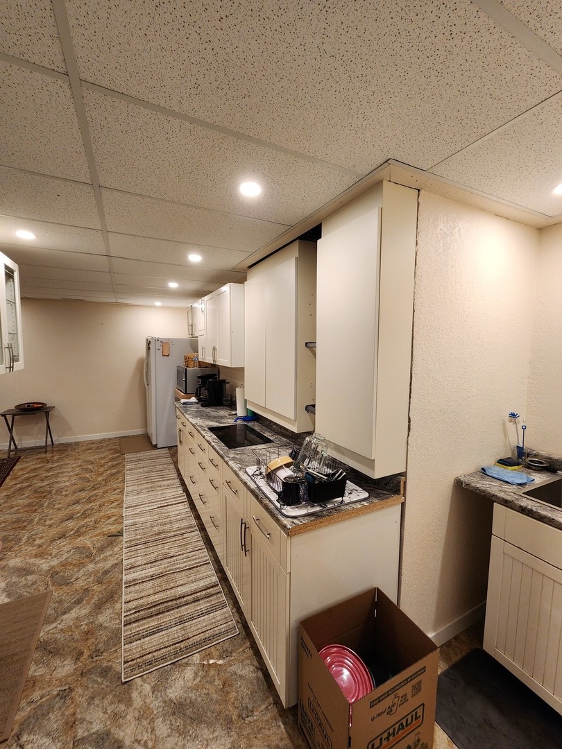 1504 Marshland Way, Unit BASMENT Bull Valley, IL 60098 - Photo 14 of 16 a kitchen with stainless steel appliances kitchen island granite countertop a stove a sink and a refrigerator