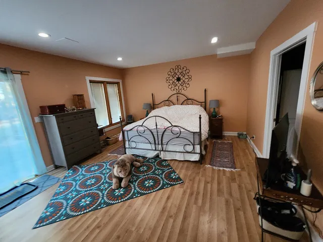 a bedroom with a bed and a mirror