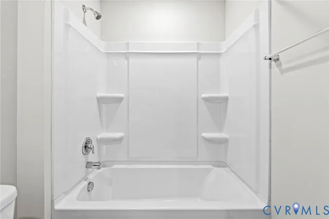 a white bath tub sitting next to a white toilet