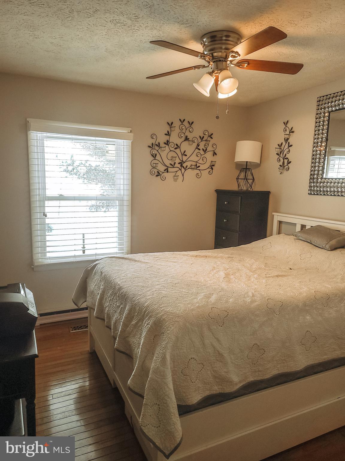 4 Meadow Court Rising Sun, MD 21911 - Photo 6 of 7 a bedroom with a bed mirror and a window