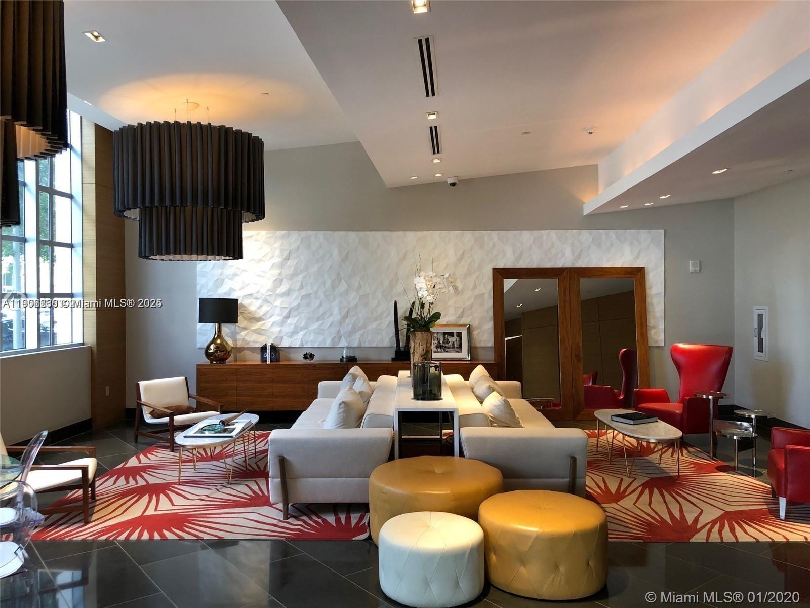 3301 Northeast 1st Avenue, Unit H1806 Miami, FL 33137 - Photo 15 of 22 a living room with furniture fireplace and a flat screen tv