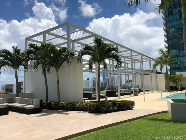 a terrace with outdoor seating and barbeque oven