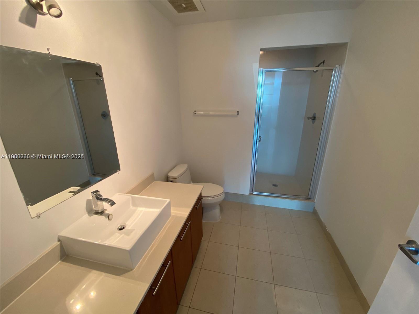 3301 Northeast 1st Avenue, Unit H1806 Miami, FL 33137 - Photo 4 of 22 a bathroom with a sink a toilet and mirror