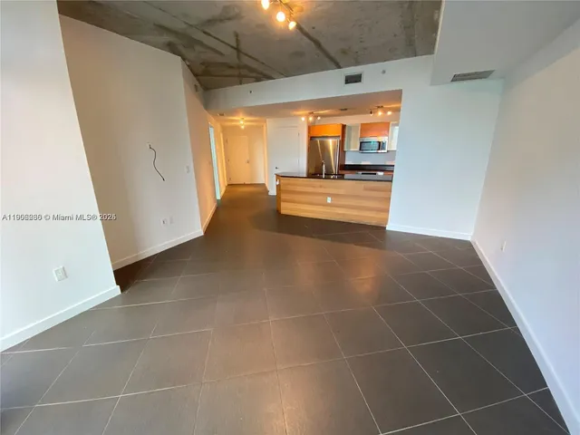 a view of a hall with an empty space and a window