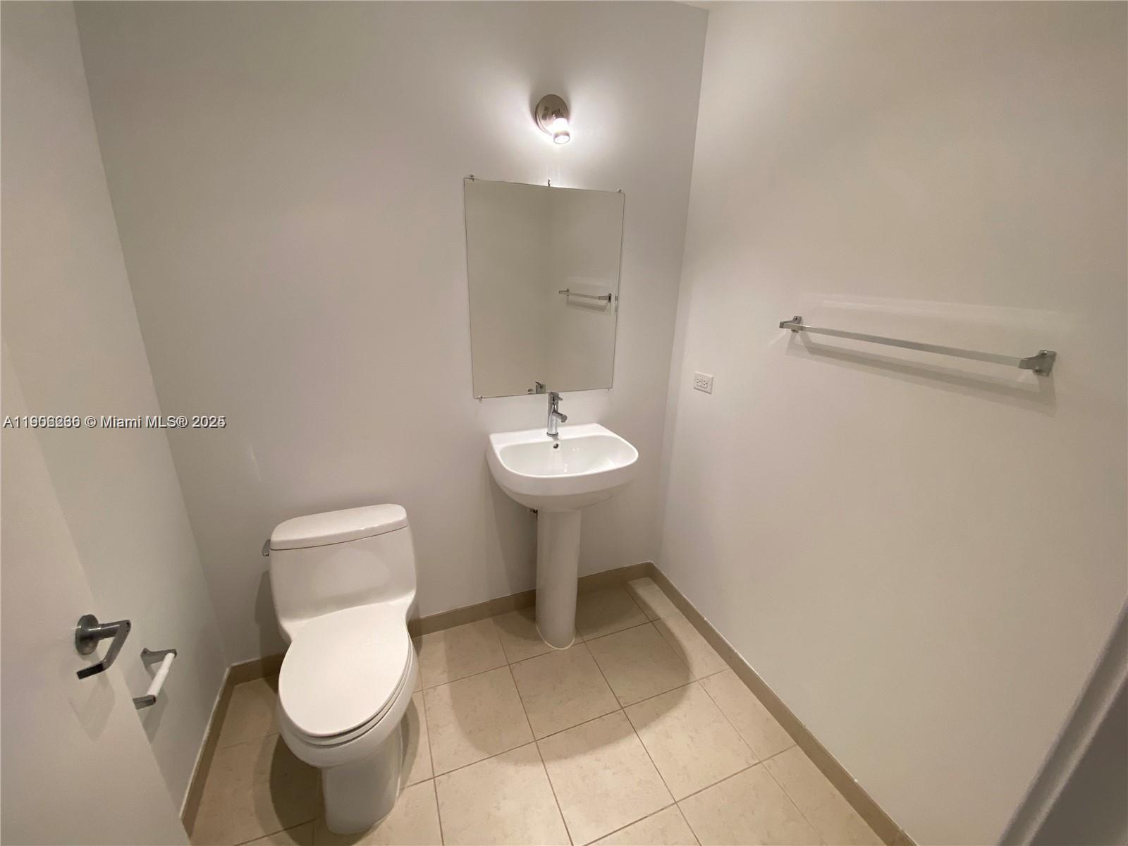 3301 Northeast 1st Avenue, Unit H1806 Miami, FL 33137 - Photo 10 of 22 a bathroom with a toilet sink and mirror