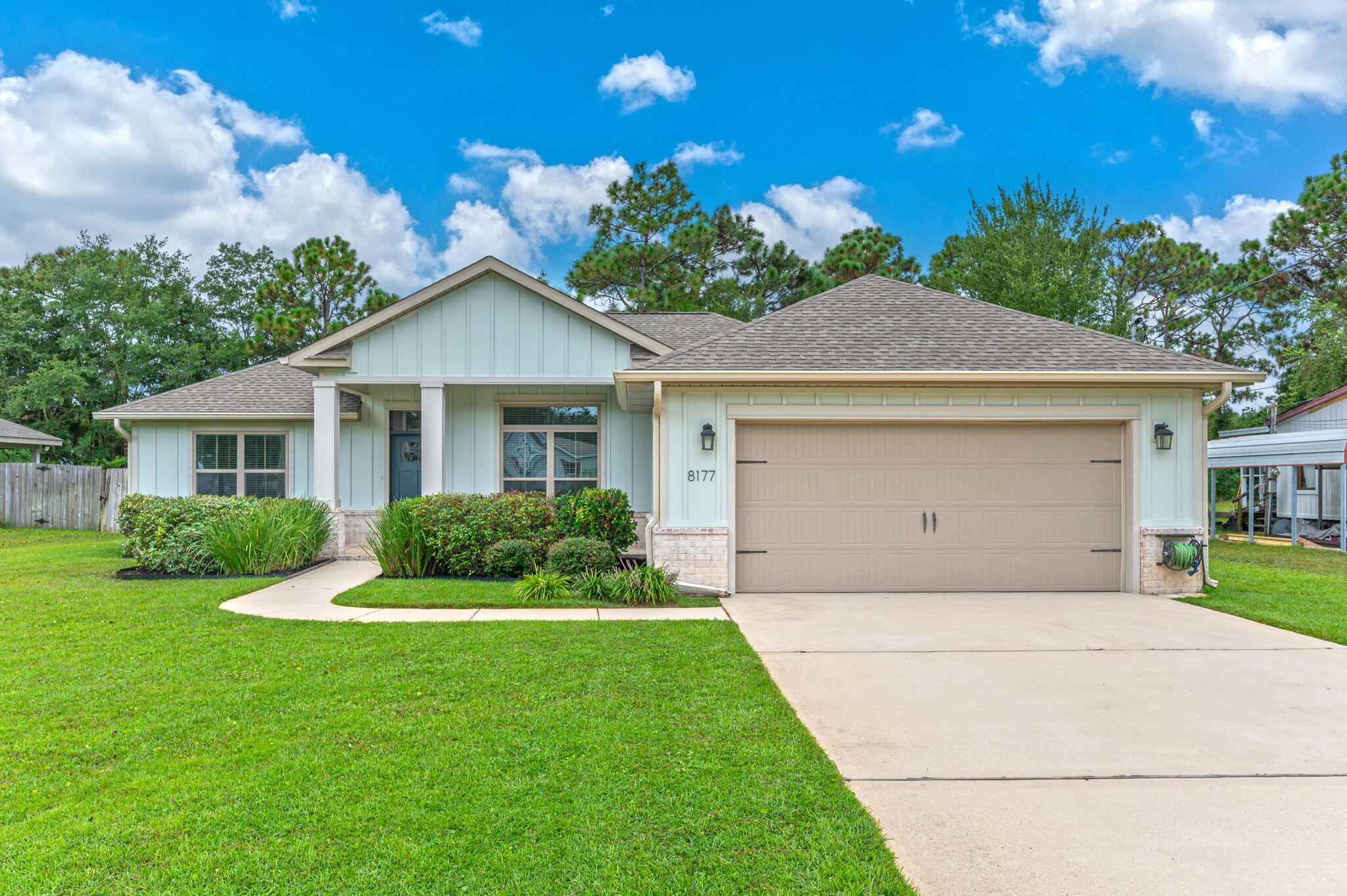8177 Lucena Street Navarre, FL 32566 - Photo 1 of 51 a front view of a house with a yard and garage