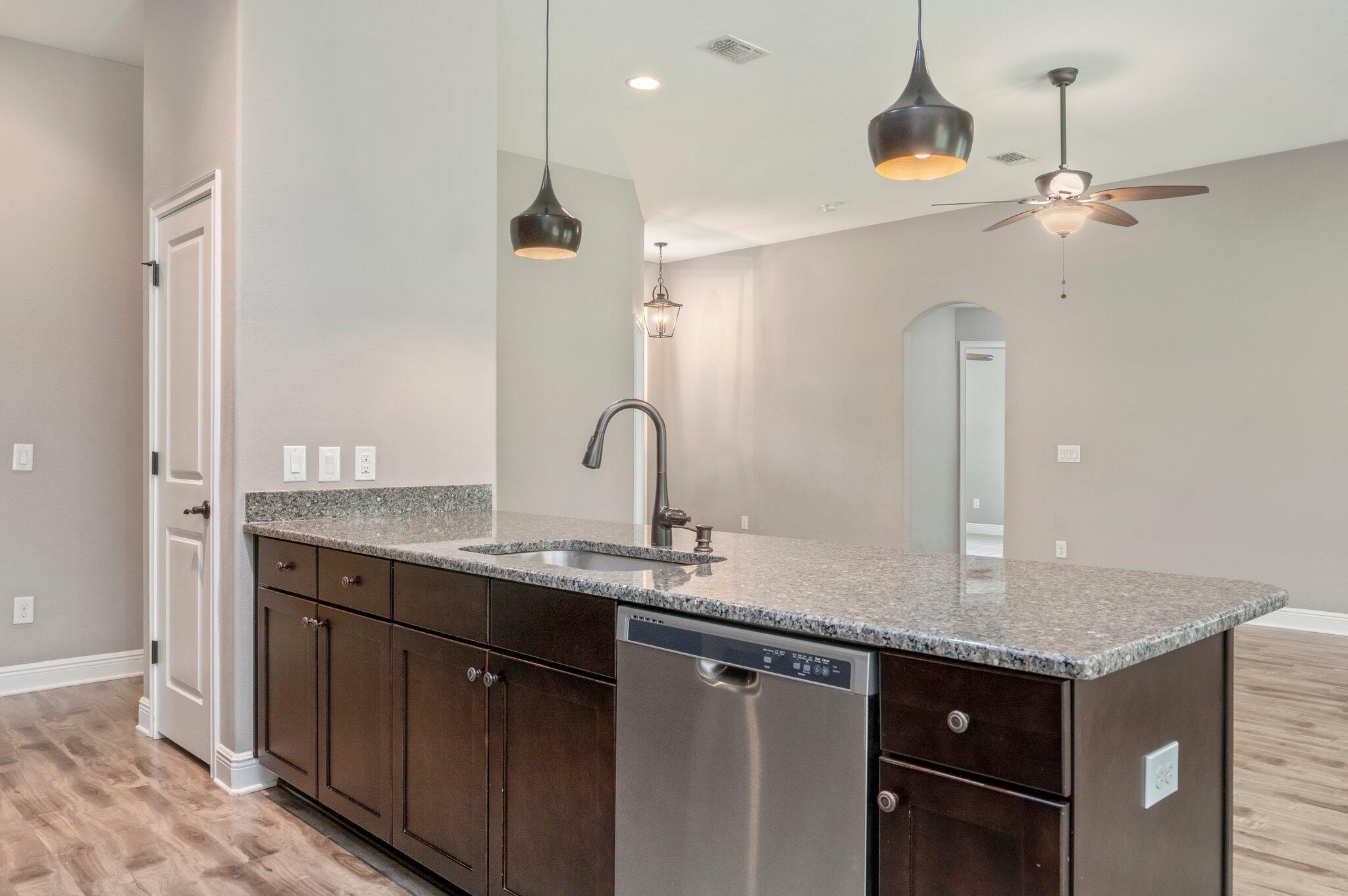 8177 Lucena Street Navarre, FL 32566 - Photo 15 of 51 a kitchen with granite countertop a sink cabinets and stainless steel appliances