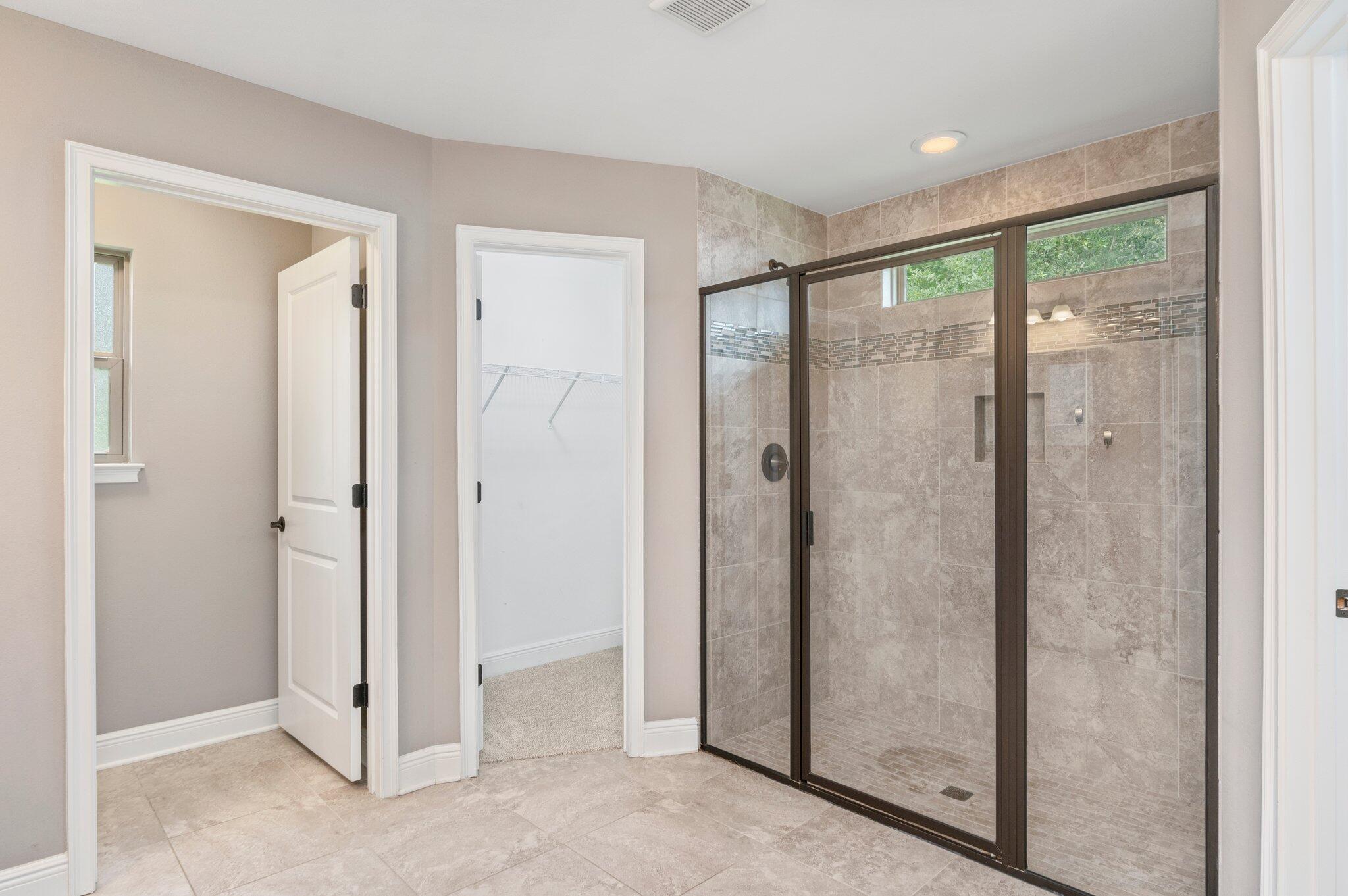 8177 Lucena Street Navarre, FL 32566 - Photo 28 of 51 a bathroom with a glass shower door