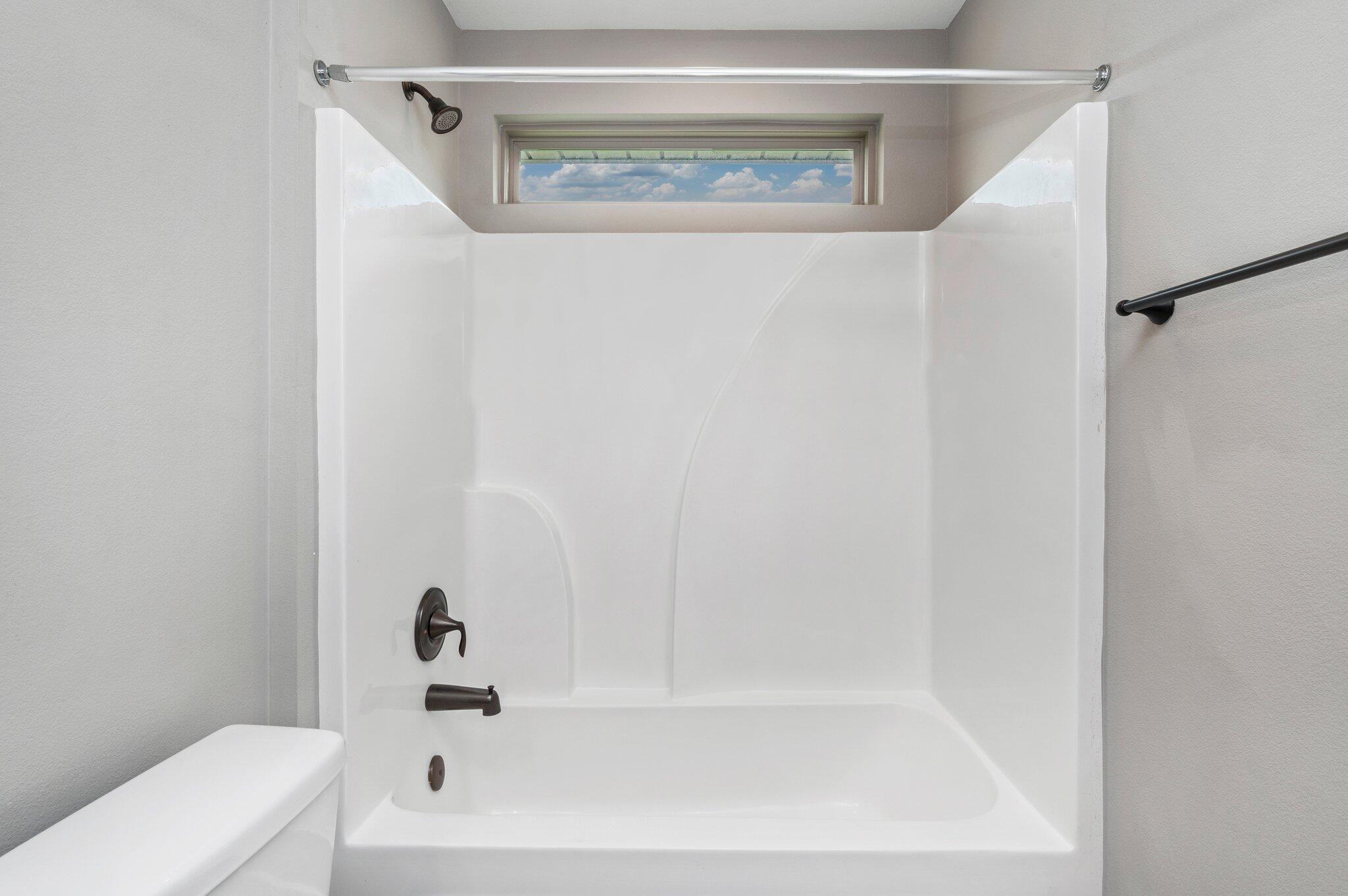 8177 Lucena Street Navarre, FL 32566 - Photo 36 of 51 a bathroom with a bathtub and a toilet