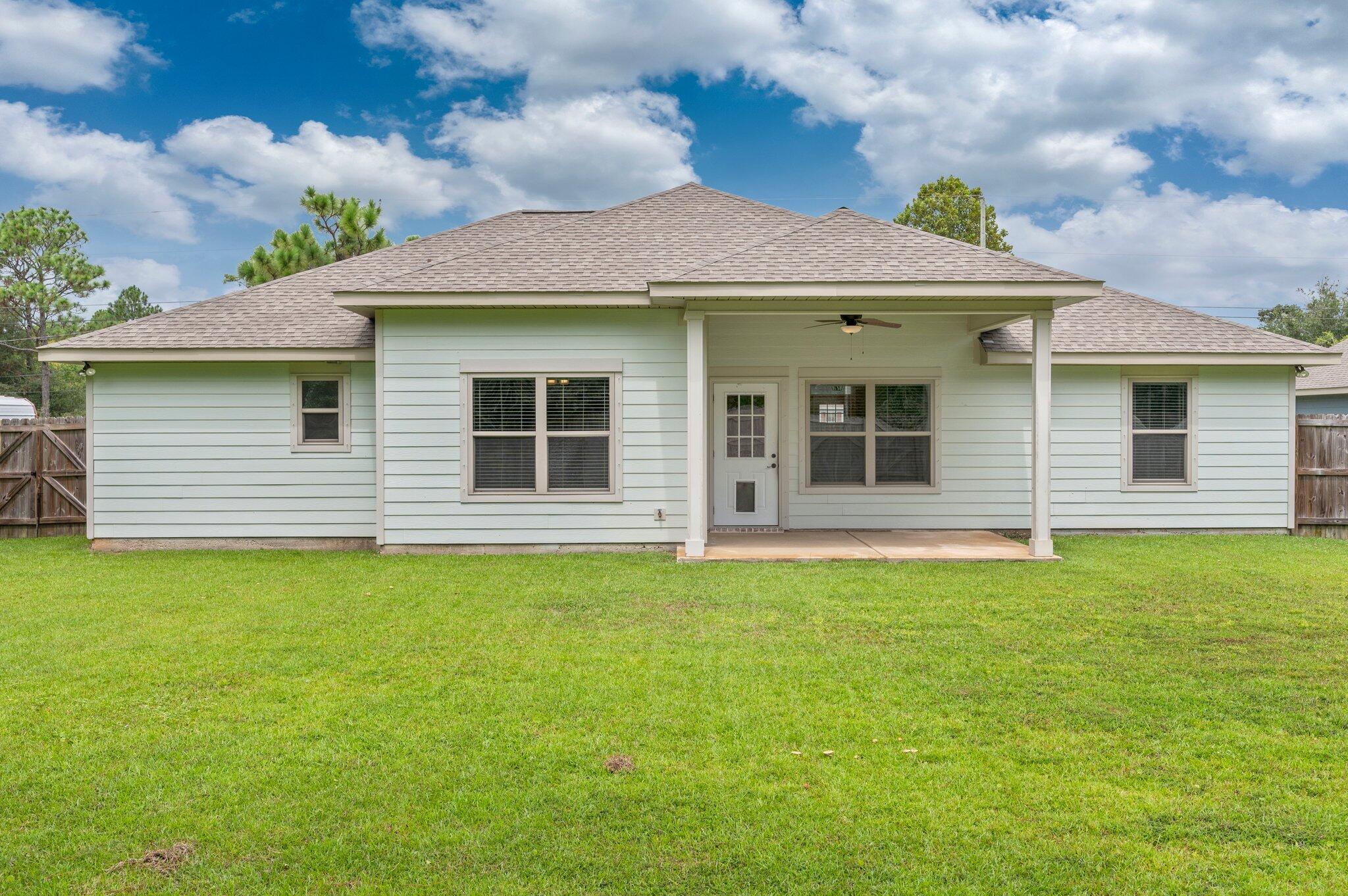 8177 Lucena Street Navarre, FL 32566 - Photo 41 of 51 a front view of a house with garden