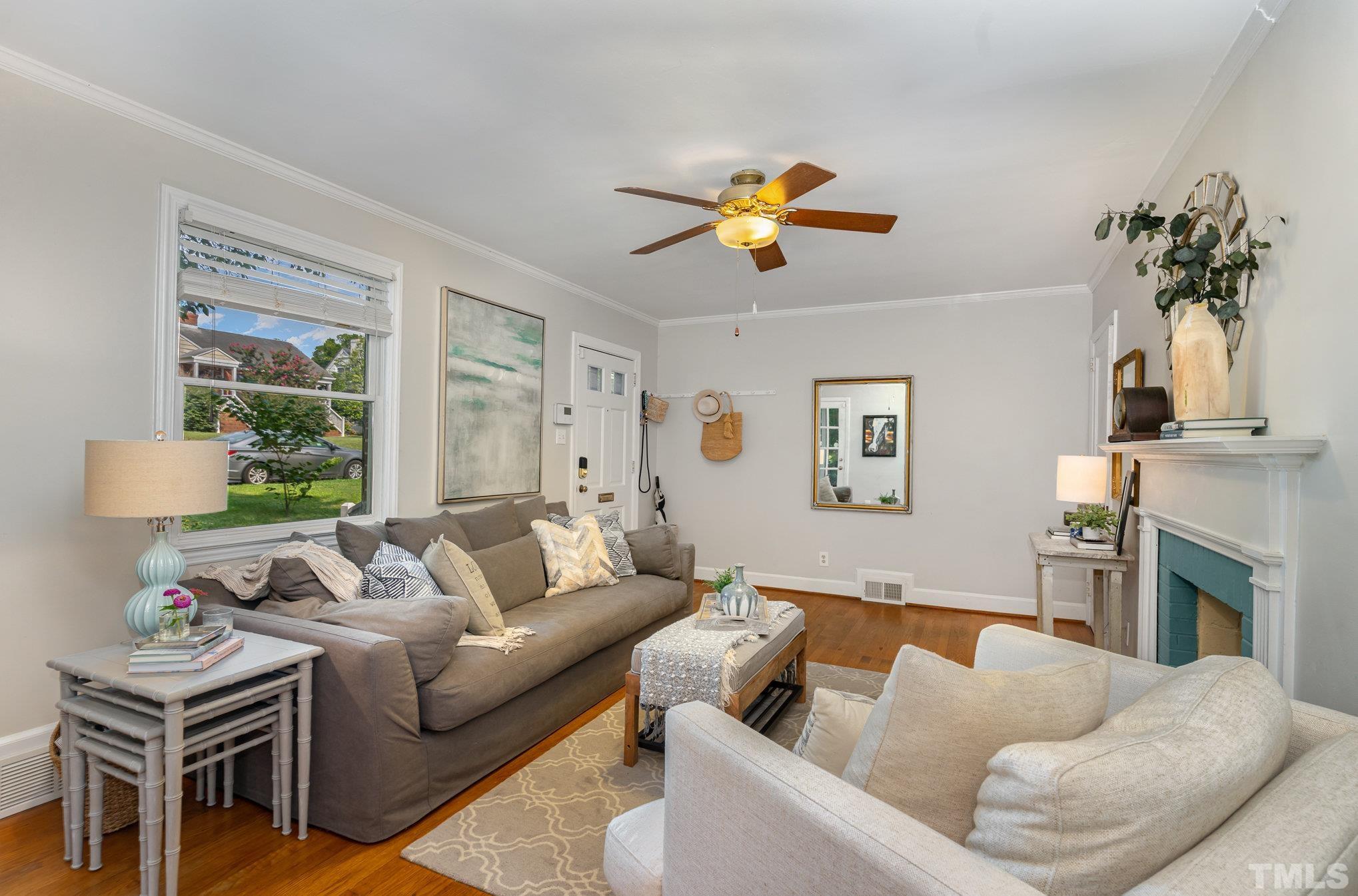 1200 Mitchell Street Raleigh, NC 27607 - Photo 5 of 31 a living room with furniture a fireplace and a potted plant