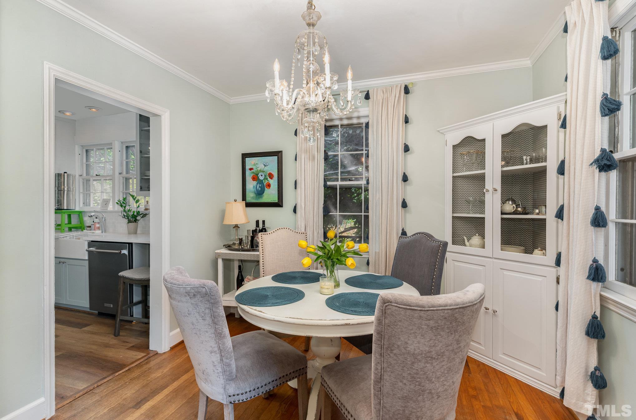 1200 Mitchell Street Raleigh, NC 27607 - Photo 7 of 31 a view of a dining room with furniture and chandelier