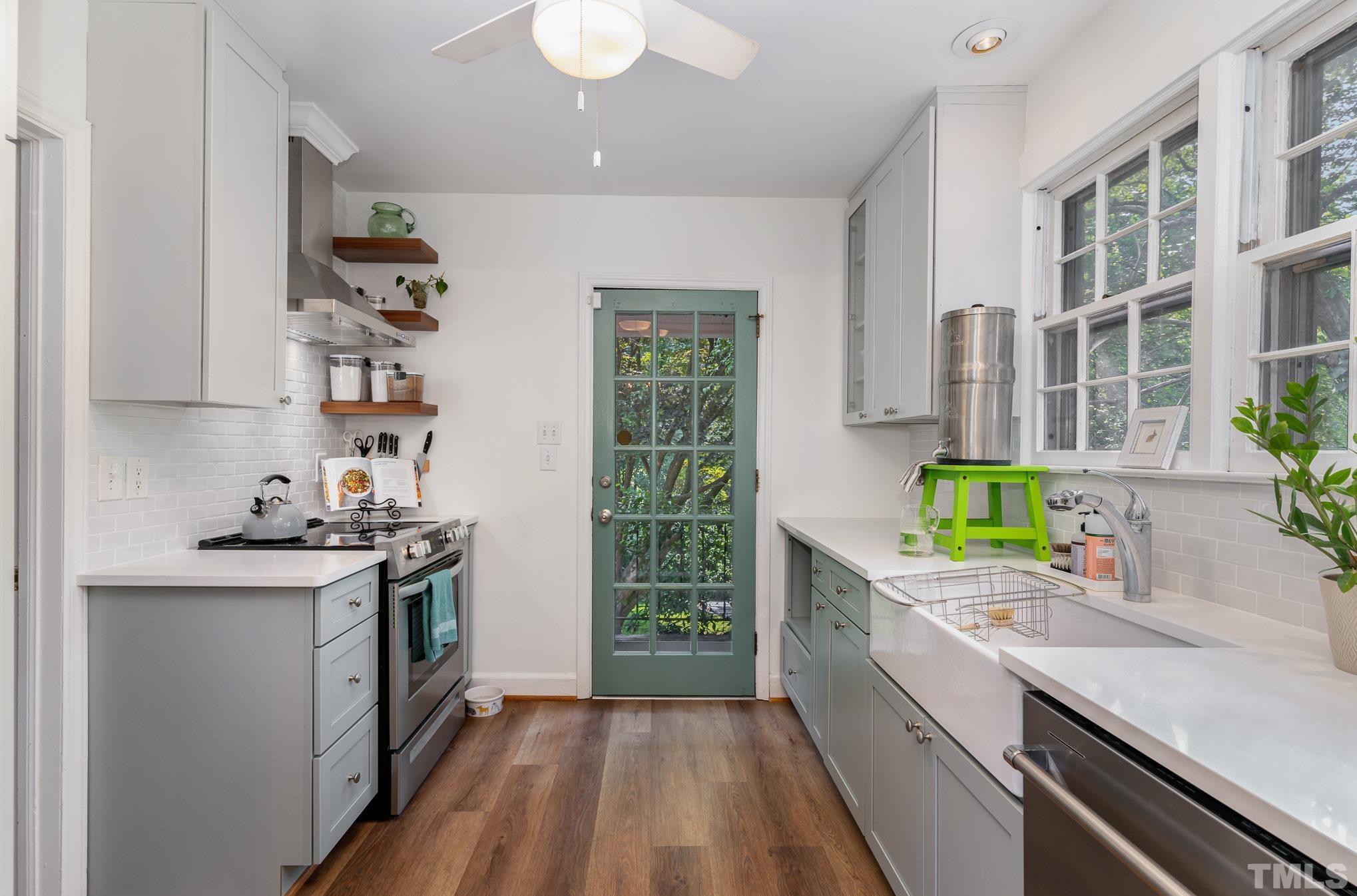 1200 Mitchell Street Raleigh, NC 27607 - Photo 10 of 31 a kitchen with a sink a stove cabinets and a wooden floor