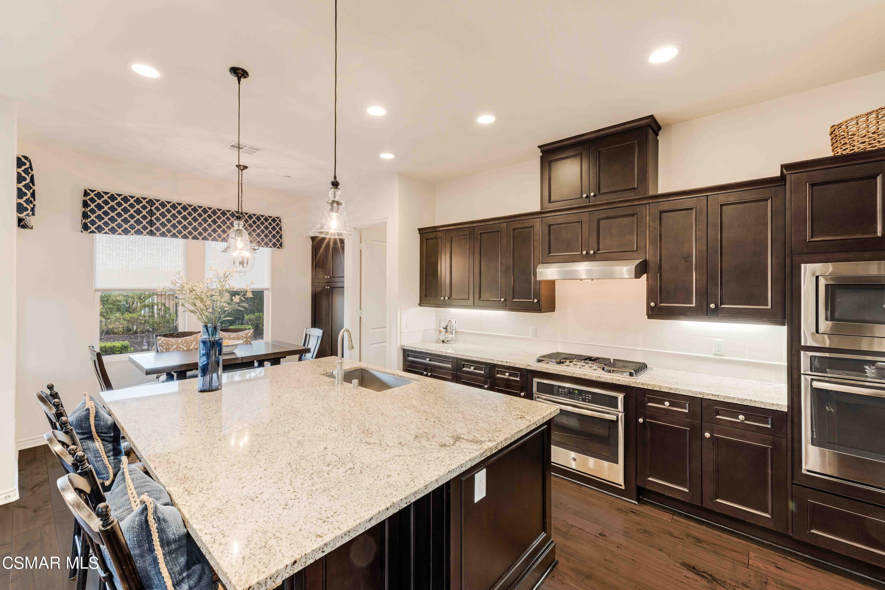 13210 Bent Grass Place Moorpark, CA 93021 - Photo 12 of 73 a kitchen with stainless steel appliances granite countertop a sink a stove and a refrigerator