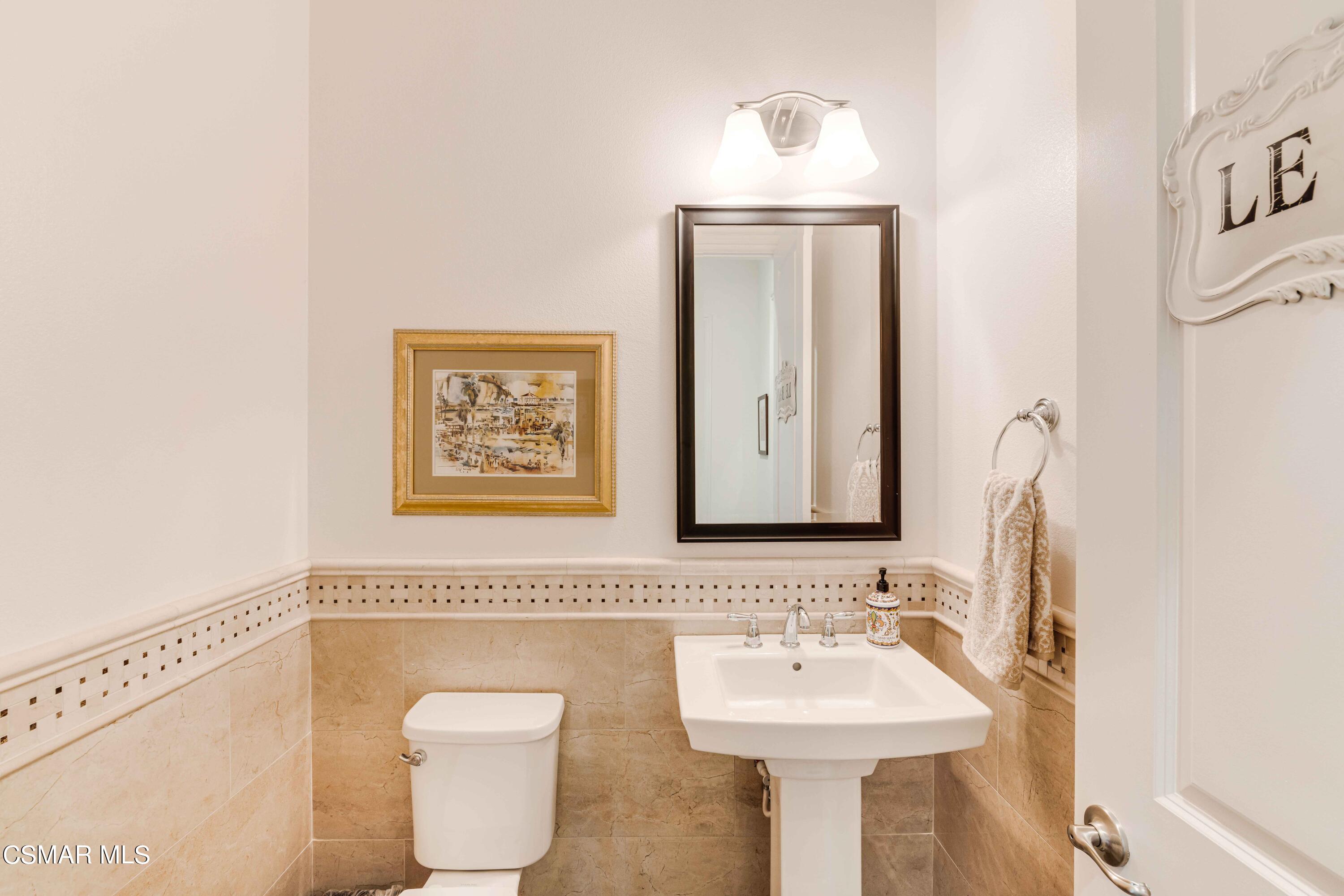13210 Bent Grass Place Moorpark, CA 93021 - Photo 17 of 73 a bathroom with a toilet sink and mirror