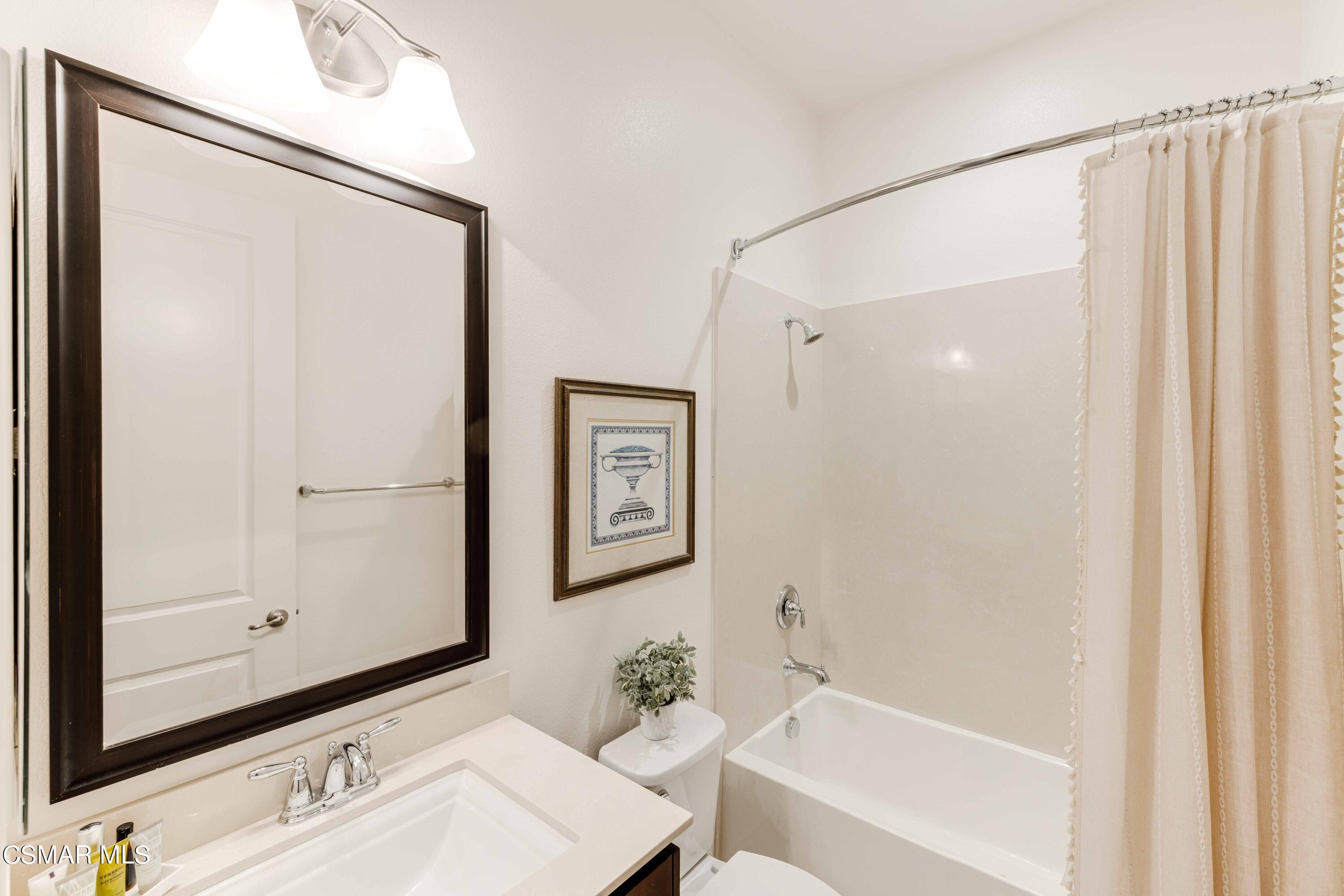 13210 Bent Grass Place Moorpark, CA 93021 - Photo 37 of 73 a bathroom with a shower a sink and a mirror