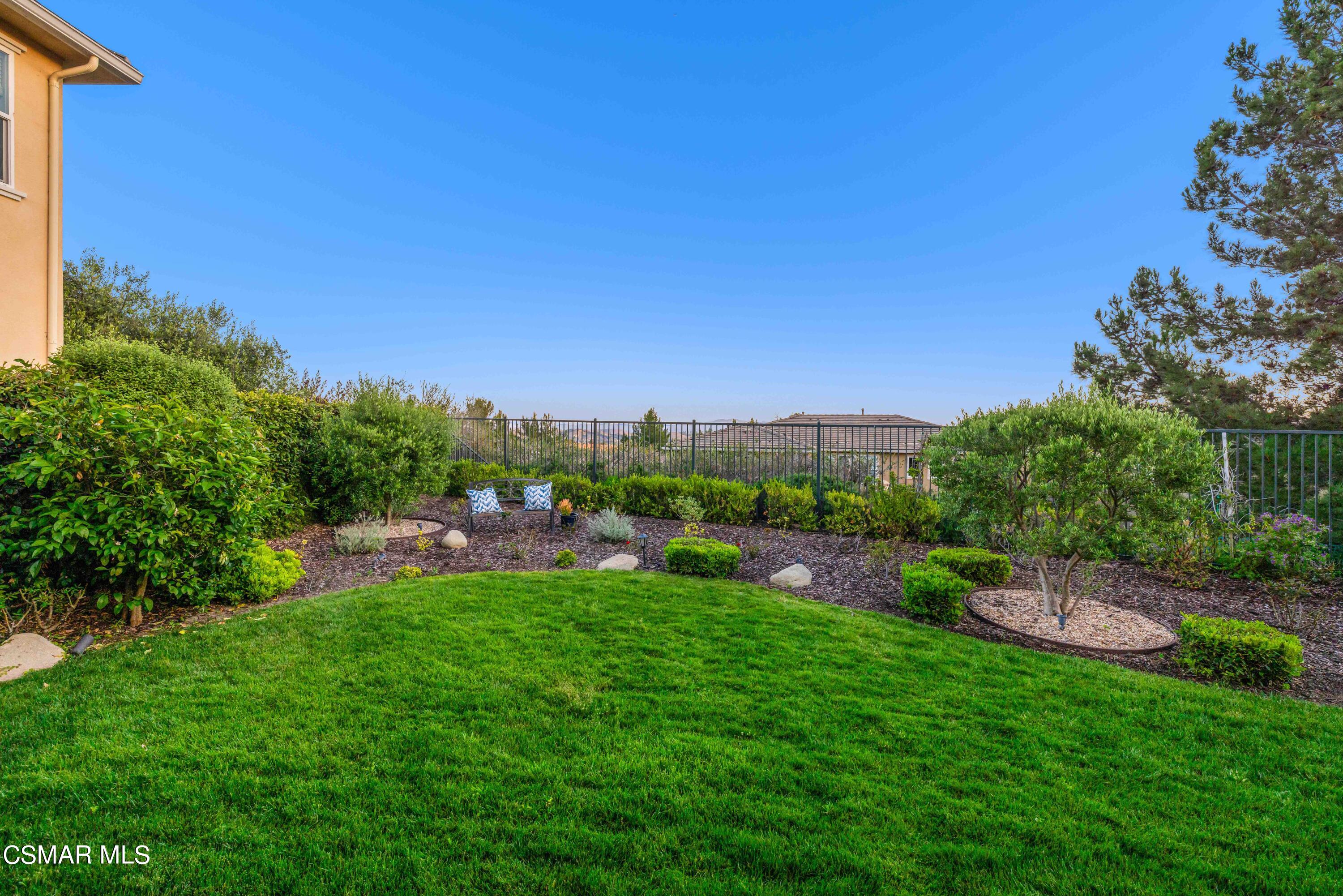13210 Bent Grass Place Moorpark, CA 93021 - Photo 41 of 73 a view of a garden with a building in the background