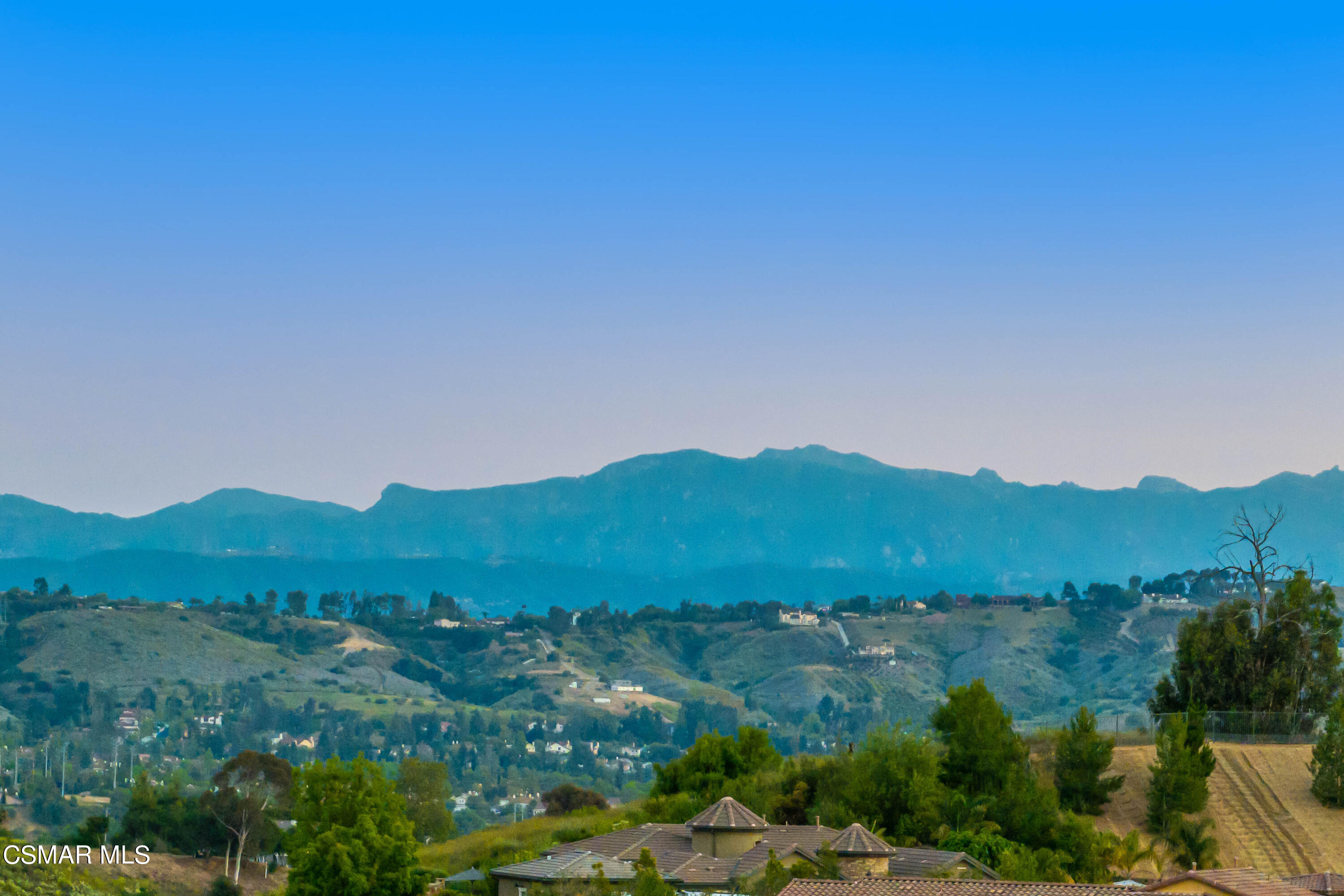 13210 Bent Grass Place Moorpark, CA 93021 - Photo 42 of 73 a view of a lush green field with mountains in the background