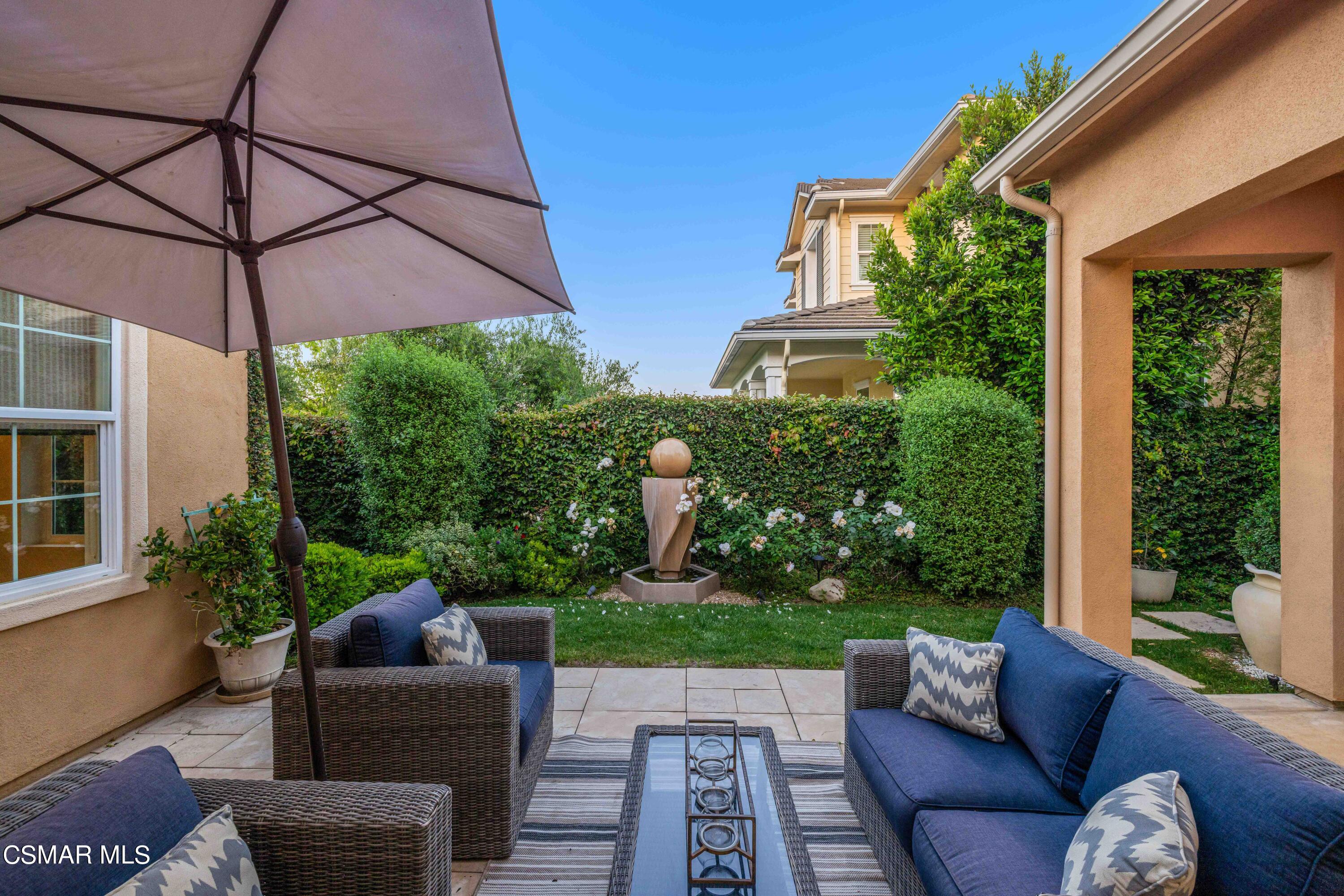 13210 Bent Grass Place Moorpark, CA 93021 - Photo 45 of 73 a view of a patio with couches table and chairs under an umbrella
